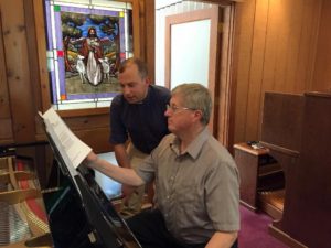 Music Director Stan Hanson (seated) and the Rev. Joseph Graumann Jr. discuss music selections for the Sept. 18 installation service at St. Stephen Lutheran Church. (Photo/submitted)
