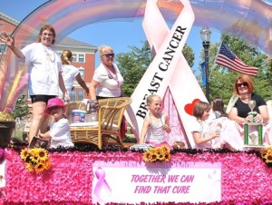 Four-time cancer survivor Vikki Crowley (far left) and Team Vikki promote the Just ‘Cause Breast Cancer Walk while riding on a float in this year’s Marlborough Labor Day Parade.