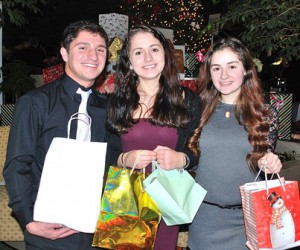 Collecting personal items at the 2013 Evening of Giving to be donated to Roland's House are (l to r) Tony Maenhout, Fatima Awada and her sister, Ivana.  File photo/Ed Karvoski Jr.  
