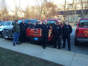The highlight of the holiday season for several Marlborough firefighters was bringing Christmas dinners to low-income families. Making the home deliveries were (left to right) Omar Torres, Brian Gould, Jeff Gagan, Bob Dolan, Joe Arsenault, Dave Logan, Ken Hancock, Jay DeGiacomo , and Ed Matthews.