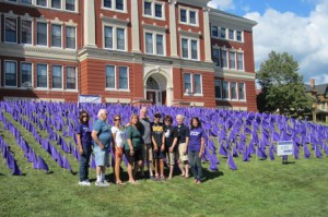 Volunteers stand in front of the 1,200 flags placed in front of the Walker Building. Photo/Bonnie Adams 