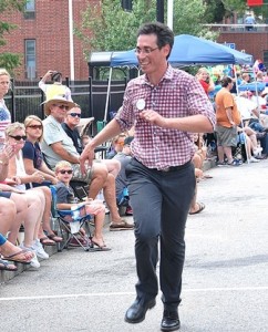 Evan Falchuk, a United Independent Party candidate for governor, runs to catch up with his marching unit.