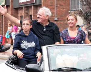 Honored as the grand marshal is Bob Kays (center), who is joined by the daughters of his friend Stefani Ferrecchia, (l to r) Isa and Gabby.