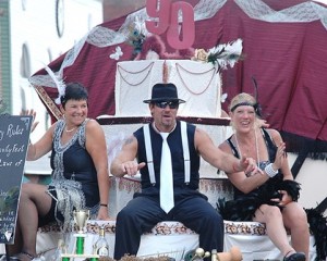 (l to r) Lucy Servidio, Michael Letendre and Jackie Smith celebrate the 90th anniversary of the Marlborough Regional Chamber of Commerce on a float, which received the Judges Trophy. 