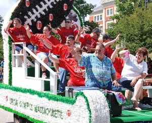 Athletes from the Special Olympics Massachusetts football team wave to parade spectators.