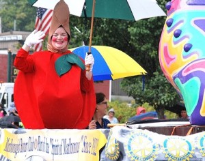 Peggy Sheldon, secretary, waves from the Marlborough Rotary Club's float, which won the Judges