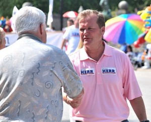 A parade spectator meets Hopkinton Selectman Brian Herr, Republican candidate for the U.S. Senate.