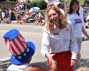 A patriotically dressed parade viewer is spotted by Ann Wofford, Republican candidate in the 3rd Congressional District.