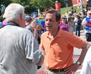 A parade spectator meets Treasurer Steve Grossman, a Democratic candidate for governor.