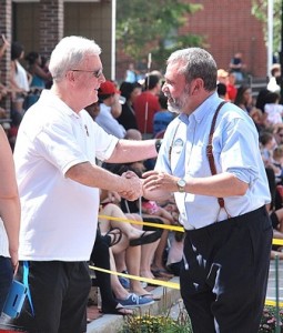 A parade viewer shakes hands with Carmine Gentile, a Democratic candidate for 13th Middlesex state representative.