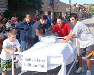 Past President Marlene King (second from left) instructs the winning team sponsored by Sully’s First Edition Pub – (l to r) Marcus Chrisafideis, 10, and 16-year-old friends Nick Coppola, Jason Plaurt and Michael Sullivan