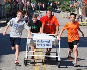 Finishing a close second place in 1:49 is the team sponsored by Marlborough Savings Bank consisting of representatives from the Marlborough High School cross country team: (l to r) Jeremy Bonds, sophomore; Sheldon Vigeant, coach; Jeff Downin, coach; and Owen Crisafulli, freshman. 