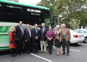 Standing in front of the new commuter bus that will transport residents to and from Marlborough and downtown Boston, are (l to r) Astrid Glynn, MassDOT Rail and Transit administrator, State Sen. Jamie Eldridge, State Rep. Carmine Gentile, Mayor Arthur Vigeant, City Council President Edward Clancy, State Rep. Danielle Gregoire, Council on Aging Director Trish Pope and City Councilor Donald Landers. Photo/submitted 
