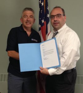 David Filosa of Milford (left), a letter carrier in Marlborough, was recognized for his 35 years of service with the U.S. Postal Service by Postmaster Nicholas Tselikis. (Photo/submitted)