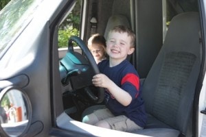 Carter, 5, drives the Patriot Ambulance with sister Katie driving along.