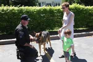 Mary Fay and son Cameron, 3, meet Officer Ken McKenzie and Kaiser.