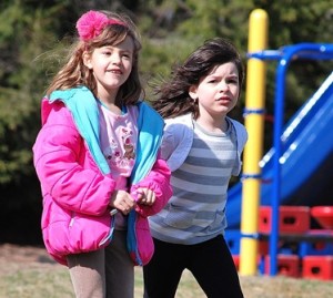 After running, kindergarteners Victoria DeFreitas and Cecilia Camaro slow their stride for the last lap.