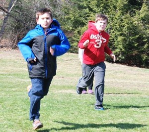 Second-grader Sean Hyland and first-grader Dane Garson run laps.  