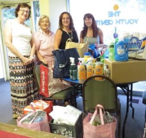 Displaying the toiletries and cleaning goods collected are (l to r) Nancy Quintas, manager of Countryside Village, Rotarian Marilyn Perry, and Junior Woman's Club members Tammie Short and Diane Birstein. (Photos/submitted)
