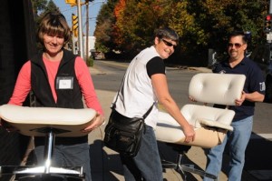 Touchstone's Volunteer Director Sue Waudby (front) is helping Kathy and Jeff Green of Marlborough move their furniture donation into the Furniture Depot. (Photo/submitted)