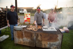 Members from Northboro Babe Ruth League man the grill at the barbecue.