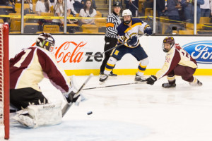 Mike Tascione blocks a shot on goal as Justin O’Connell looks on.