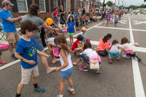Children scramble for candy thrown from the floats during the Northborough Applefest Parade. Photo/Jeff Slovin