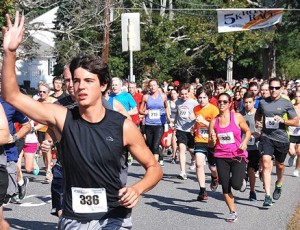 One of the 411 participants of the 22nd annual Applefest 5K Race/Walk waves toward the sidelines.