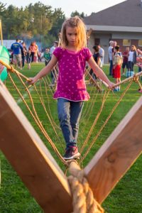 Caroline concentrates as she walks over a rope bridge set up by the Northborough Boy Scouts Troop 1. Photo/Jeff Slovin