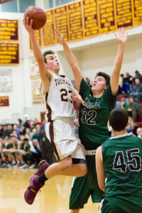 Algonquin’s Jake Clark goes up to shoot over Wachusett’s Liam Griffin