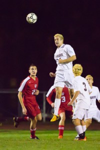 Algonquin’s Joe Wallace leaps up to head the ball.