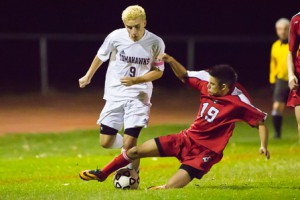 Hudson junior Kyle Andrade attempts to stop Algonquin’s Tyler Morin.