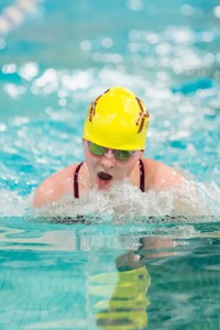 Emily Lowe competes in the Midland-Wachusett League Swim Championships Jan. 29. Photo/Jeff Slovin  