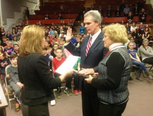 Worcester County District Attorney Joseph D. Early Jr. is sworn in for his third term by Lt. Gov. Karyn Polito at the Melican Middle School in Northborough. The DA's mother Marilyn Early is holding the family bible.