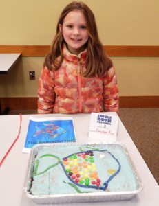 7 year old Claire Stroscio of Westborough with her work, “The Rainbow Fish” (created by her and her siblings, Daniel and Sarah)