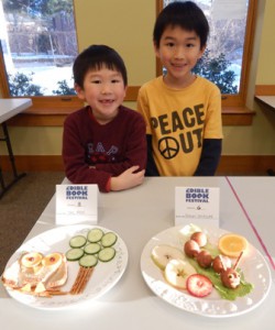 Brothers Gary (left) and Terry Chang with their edible books, “Owl Moon” and “The Very Hungry Caterpillar”