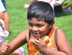 Surya Kumar, 5, scampers on the field as he plays pass the potato.