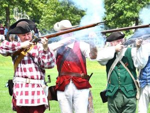 Musket firing is demonstrated by Sudbury Companies of Militia & Minute members.