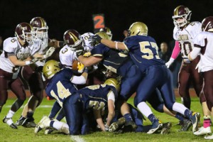 Algonquin’s Kaio Menezes (#23) is brought down by a gang of Shrewsbury tacklers. 
