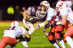 Algonquin’s Max Cerasoli (#42) attempts to power through numerous Hudson tacklers.