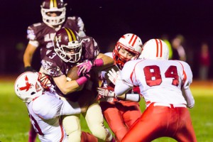 Algonquin’s Billy Polymeros (#3) is tackled by a host of Hudson players.