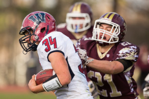 Westborough’s Anthony Casparriello (#34) carries the ball as Algonquin’s Thomas Polutchko (#21) attempts to tackle him.