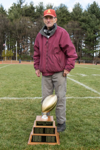 Richard “Dick” Walsh poses with the Joseph Mewhiney-Richard Walsh Annual Thanksgiving Day Trophy.