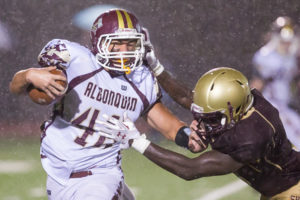 Algonquin’s Max Cerasoli tries to evade a tackle by Shepherd Hill’s Kevin Mensah.