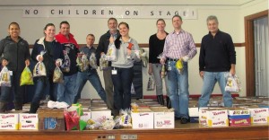 Genzyme Northborough Operations Facility employee volunteers help to pack food baskets for families in need.