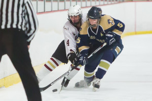 Algonquin’s Anna MacDonald (#4) and Shrewsbury’s Ashley Ljunggren (#5) fight for the puck along the boards