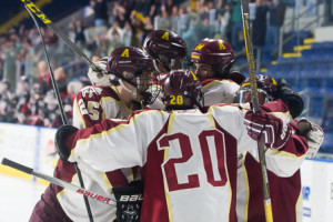 Ian Kosovsky (#20) hugs teammates after scoring one of his two goals.
