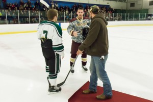 Elliot Arsenault shakes hands with Algonquin’s Matt Tozeski and Wachusett’s Connor Bernard after dropping the ceremonial first puck