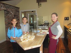 Taylor and Ashley Mayo have a waffle sample offered by Erica of C’est La Vie Bistro. The Bistro is scheduled to open in March 2016.