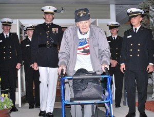 College of the Holy Cross ROTC cadets escort World War II veteran Bob Rouchette from Whitney Place Assisted Living Residences at Northborough to a limousine bound for Logan Airport for an Honor Flight New England trip to Washington, D.C.